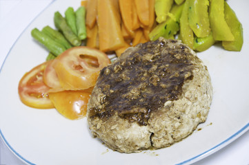 Pork Steak with vegetables on a white plate
