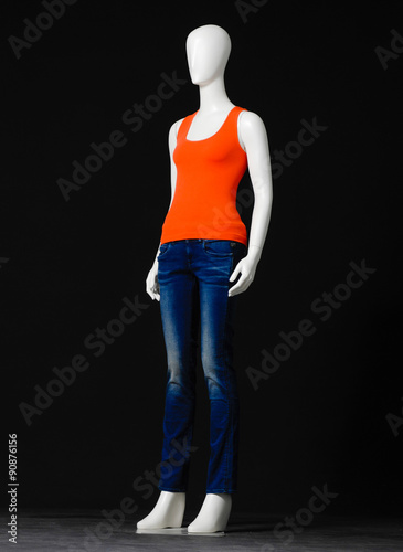 &ldquo;full-length female mannequin orange dressed in jeans on black