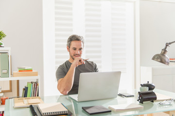 architect sitting at office working on his laptop