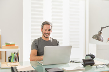 architect sitting at office working on his laptop