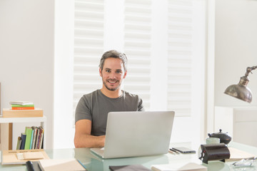 architect sitting at office working on his laptop
