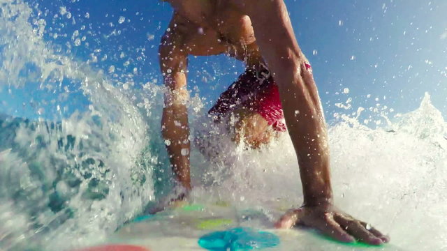 POV Surfing on Blue Ocean Wave at Sunrise. SLOW MOTION Big Wave Surfing in Red Shorts. Drop In Bottom Turn Frontside Right. Summer Fun Lifestyle Extreme Sports. 