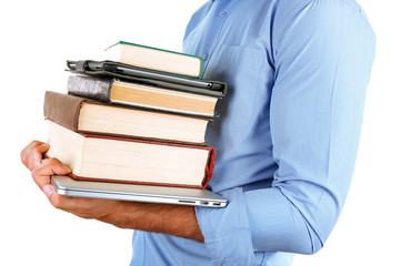 Man holding stack of books with laptop and tablet close up