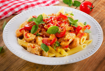 Pasta penne with meat, sauce and vegetables.