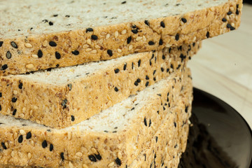 Closeup of Fresh sliced wholewheat bread with various seeds and multigrain on wood background
