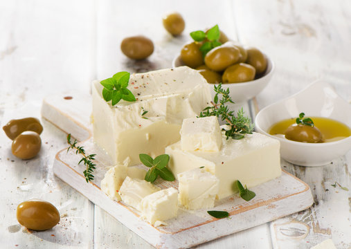 Feta cheese with green olives and herbs.