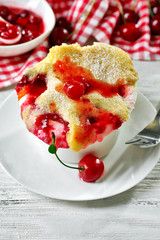 Tasty pudding with cherries on table close up