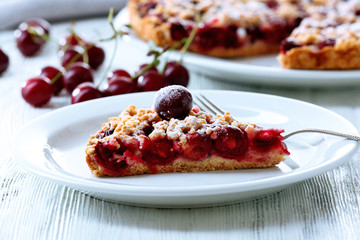 Tasty homemade pie with cherries on table close up