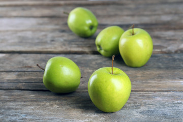 Ripe green apples on wooden table close up
