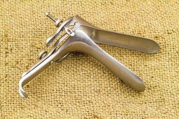 Obraz premium Medical equipment ,Gynecologic Speculum on brown sack fabric background