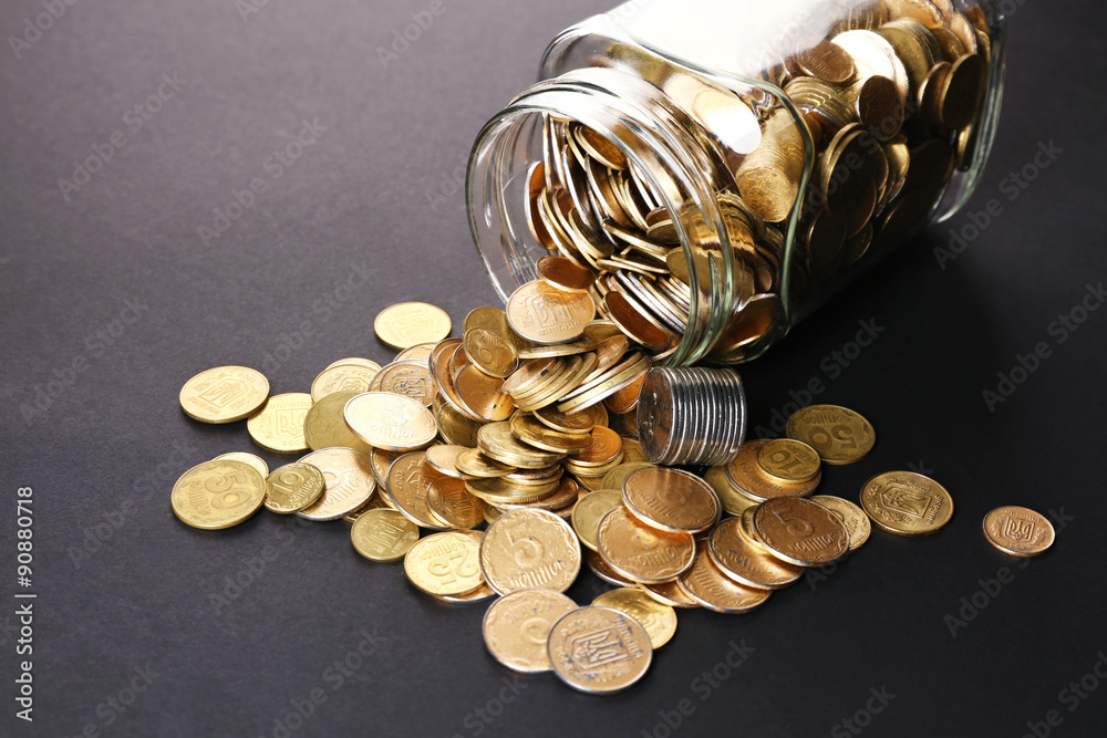 Sticker Glass jar with coins on dark background