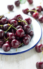 sweet cherry on a plate on wooden table