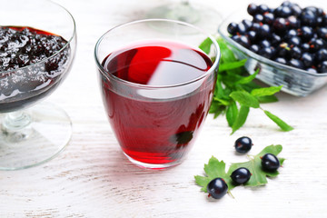 Fresh currant juice with berries on table close up