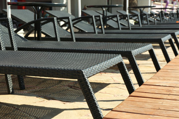 Sunbeds near swimming pool, outdoor