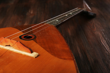 Folk musical instrument balalaika on wooden background
