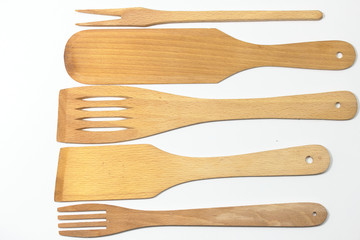 Wooden spoons, spatulas and a fork isolated on white background