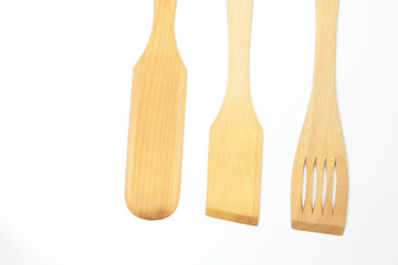 Wooden spoons, spatulas and a fork isolated on white background