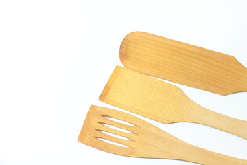 Wooden spoons, spatulas and a fork isolated on white background