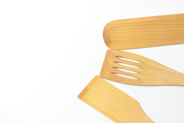 Wooden spoons, spatulas and a fork isolated on white background