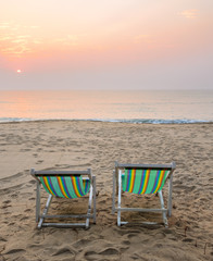 Beach sunrise with beach chairs