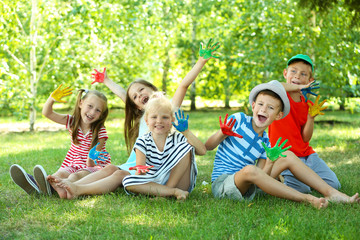 Fototapeta premium Happy active children with bright colored palms in park