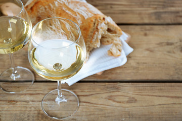 Still life of wine and bread on light background