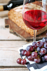 Still life of wine and bread on rustic wooden background