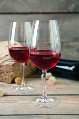 Still life of wine and bread on light background