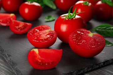 Red tomatoes on wooden background