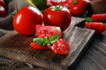 Red tomatoes on cutting board closeup