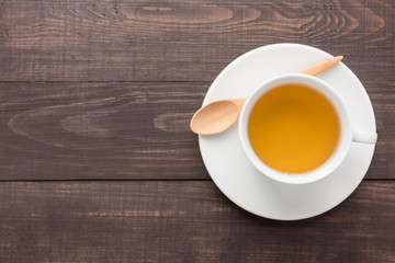 Ginger tea with lemon on the wooden background