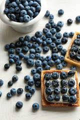 Gourmet fresh blueberry tarts on table