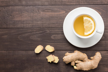 Ginger tea with lemon on the wooden background