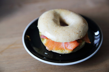 Smoked salmon bagel on wood background
