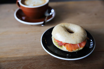 Smoked salmon bagel on wood background