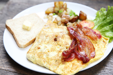 Breakfast with bacon , fried egg and bread