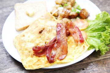 Breakfast with bacon , fried egg and bread