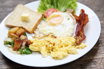 Breakfast with bacon , fried egg and bread