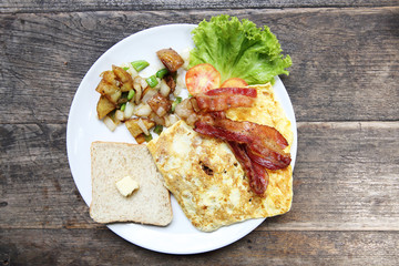 Breakfast with bacon , fried egg and bread