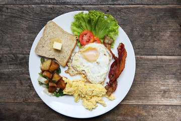 Breakfast with bacon , fried egg and bread