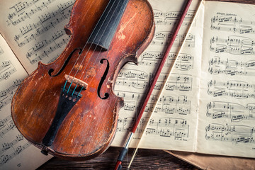 Old violin and musical sheets with ink and feather