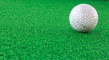 Golf ball ont the glass and blur background.