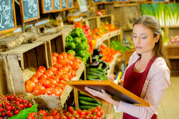 Worker writing prices onto board