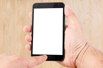 Man hand hold blank touch screen smart phone on wood texture for
