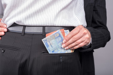 Woman stealing money in the pocket of her lover