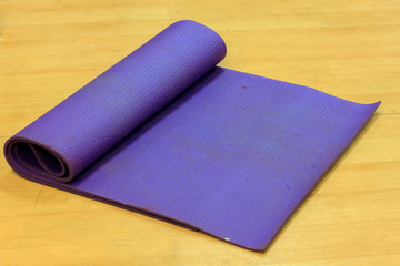 Yoka mat on wood background.