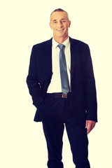Smiling businessman with hand in pocket