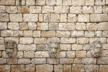 Old White Stonewall With Lion Head Decoration