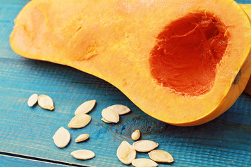 Muscat pumpkin on blue rustic background. Seasons, autumn vegetables