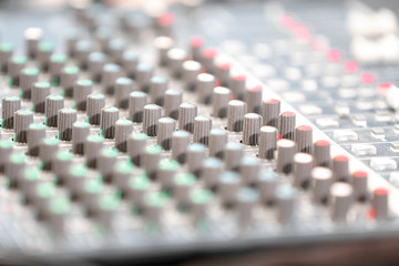Obraz premium An expert adjusting audio mixing console